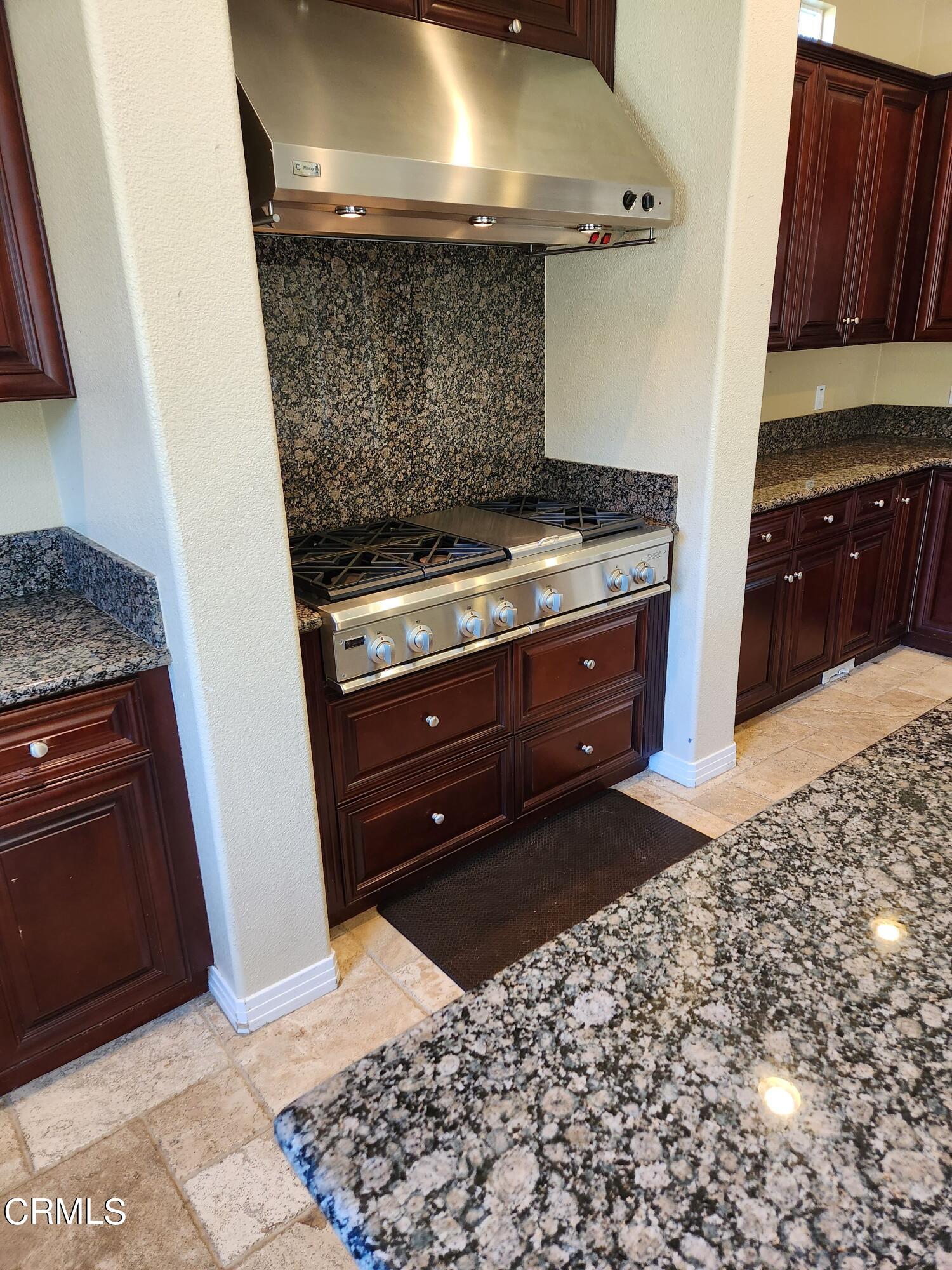 1915 Maya Pradera Lane Moorpark, CA 93021 - Photo 21 of 39 a stove top oven sitting inside of a kitchen