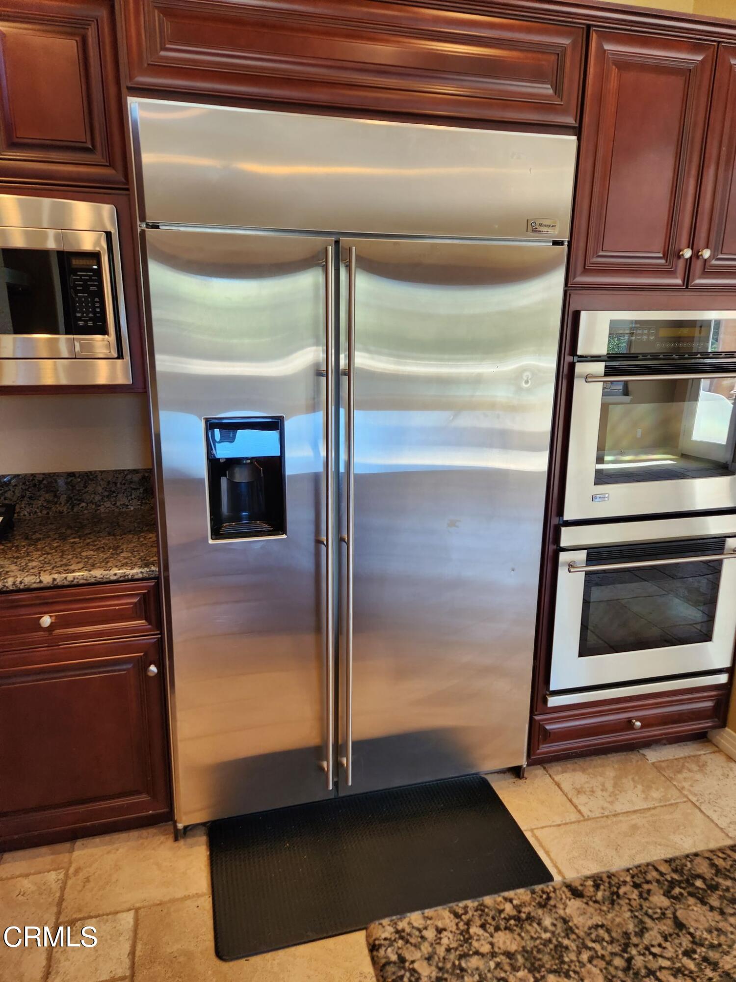 1915 Maya Pradera Lane Moorpark, CA 93021 - Photo 22 of 39 a kitchen with granite countertop a refrigerator and a stove