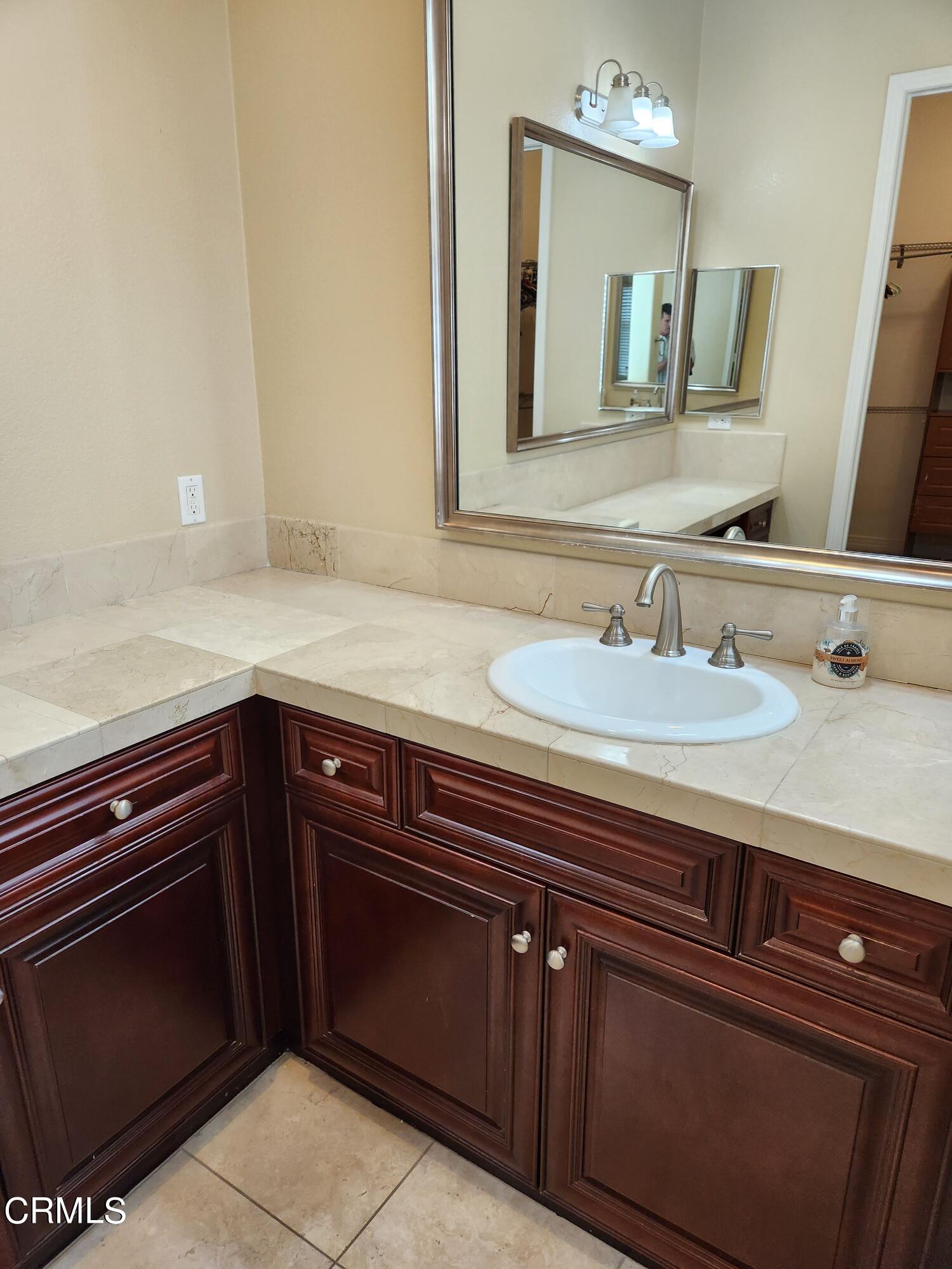 1915 Maya Pradera Lane Moorpark, CA 93021 - Photo 31 of 39 a bathroom with a sink and a mirror
