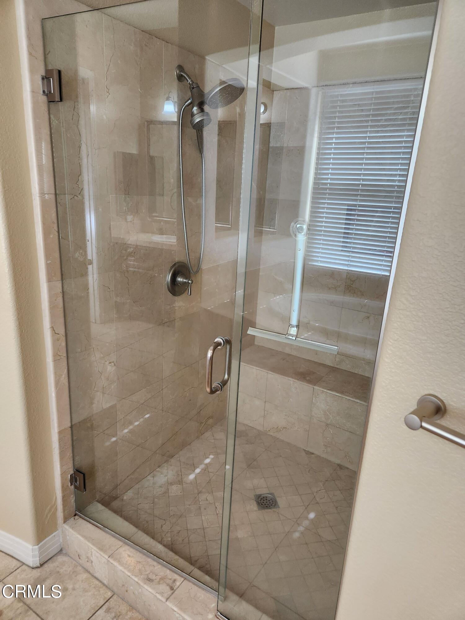 1915 Maya Pradera Lane Moorpark, CA 93021 - Photo 33 of 39 a bathroom with a glass door shower