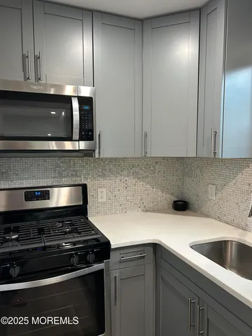 a kitchen with granite countertop stainless steel appliances and cabinets