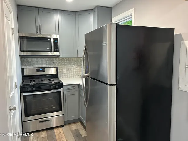a white refrigerator freezer and a stove sitting inside of a kitchen