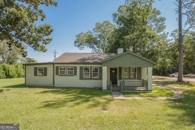 a front view of a house with a garden