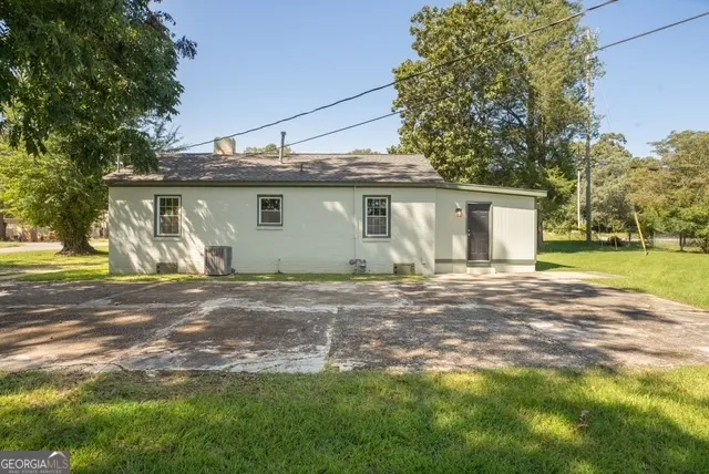 a view of a backyard with large trees