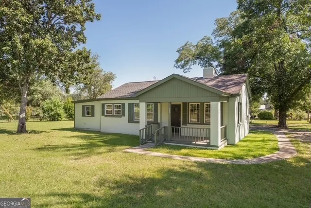 a front view of a house with a yard