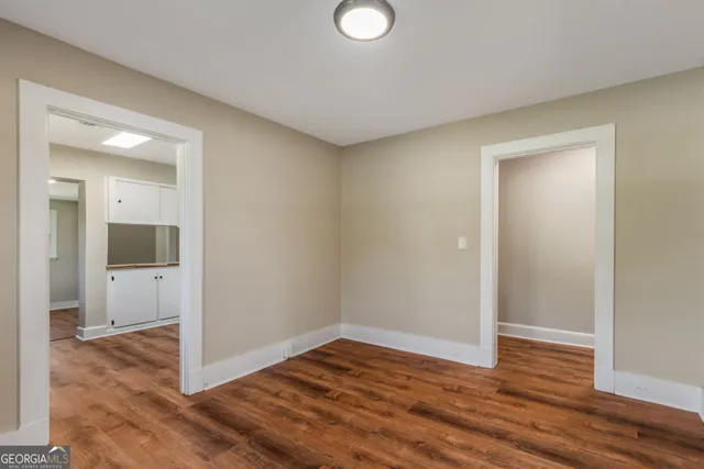 a view of a room with wooden floor and bathroom