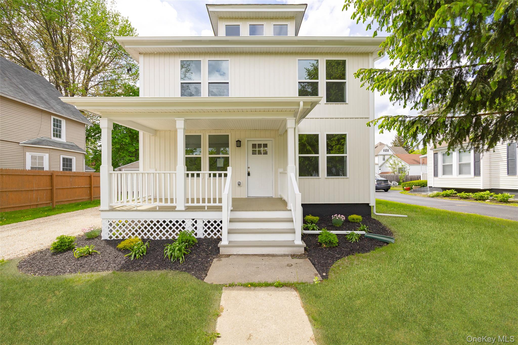 a front view of a house with a garden and plants