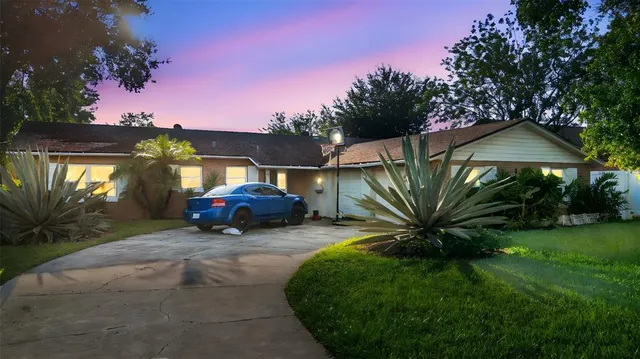 a view of a house with a yard fire pit and outdoor seating