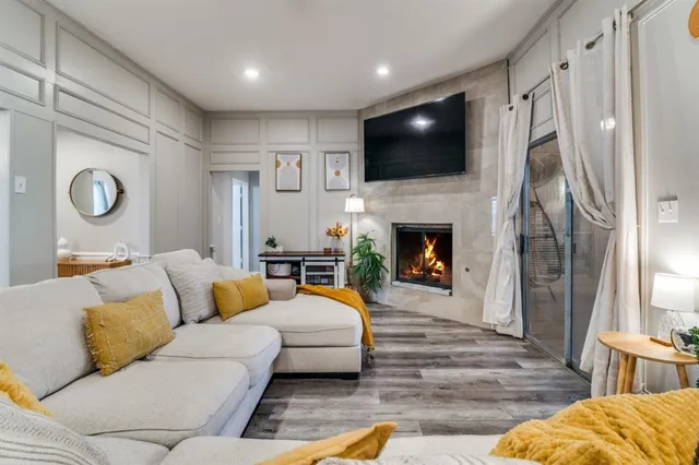 a living room with fireplace furniture and a flat screen tv