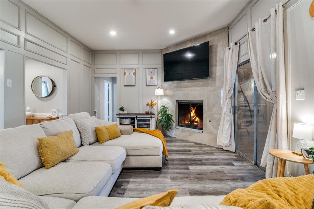 a living room with fireplace furniture and a flat screen tv