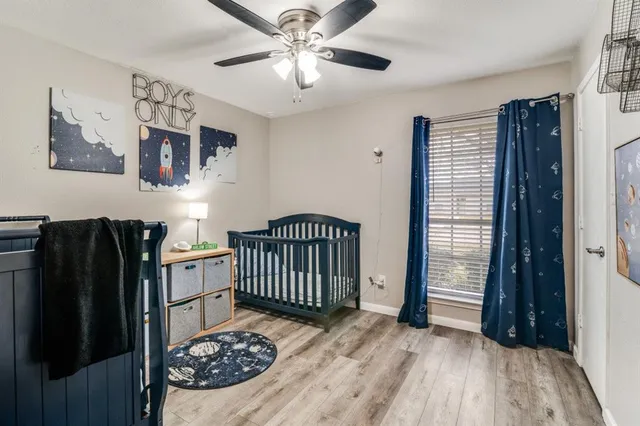 a view of a bedroom with furniture and wooden floor