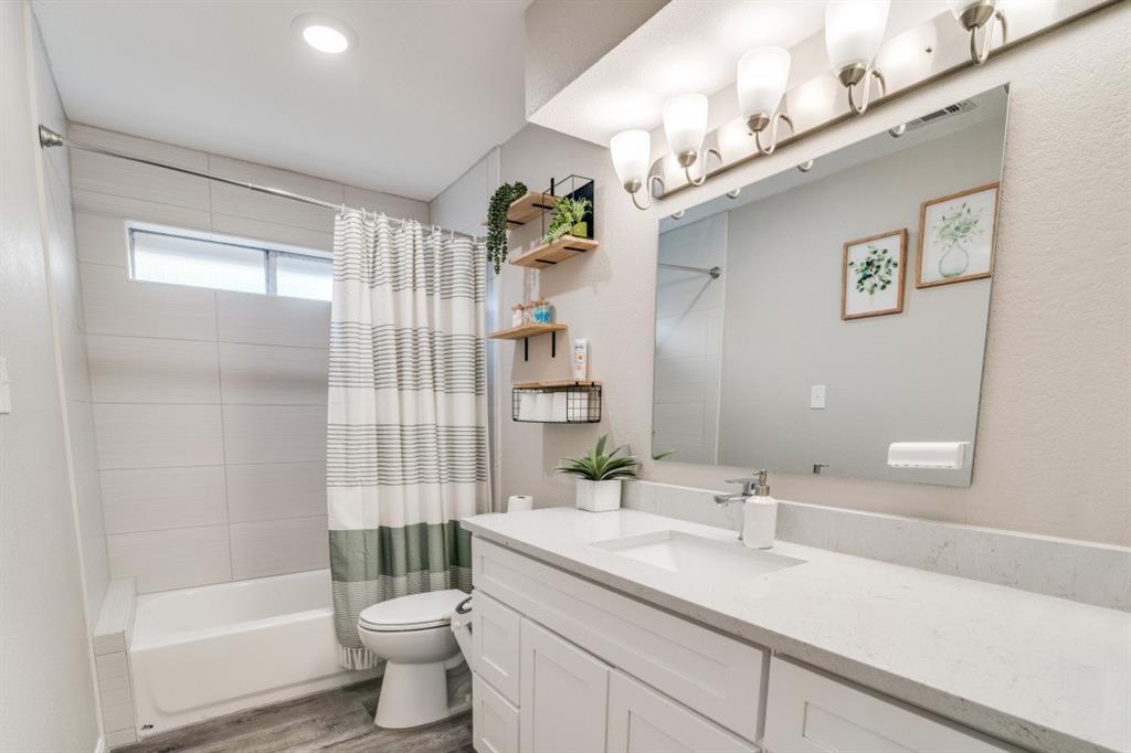 7214 Ridgeview Drive Rowlett, TX 75089 - Photo 15 of 23 a bathroom with a sink a toilet and shower