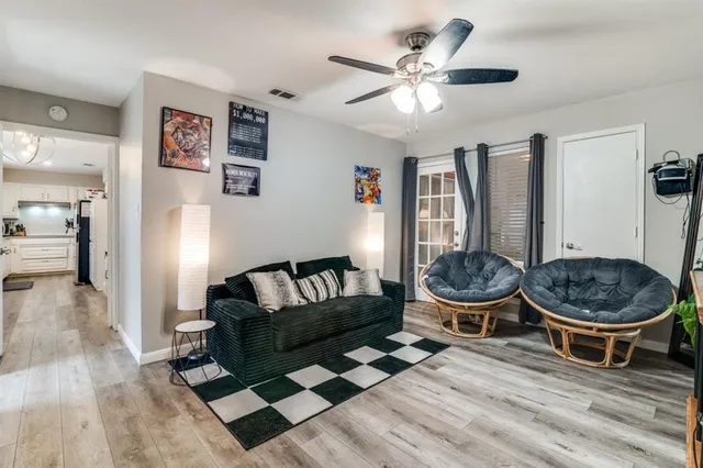 a living room with furniture and a wooden floor