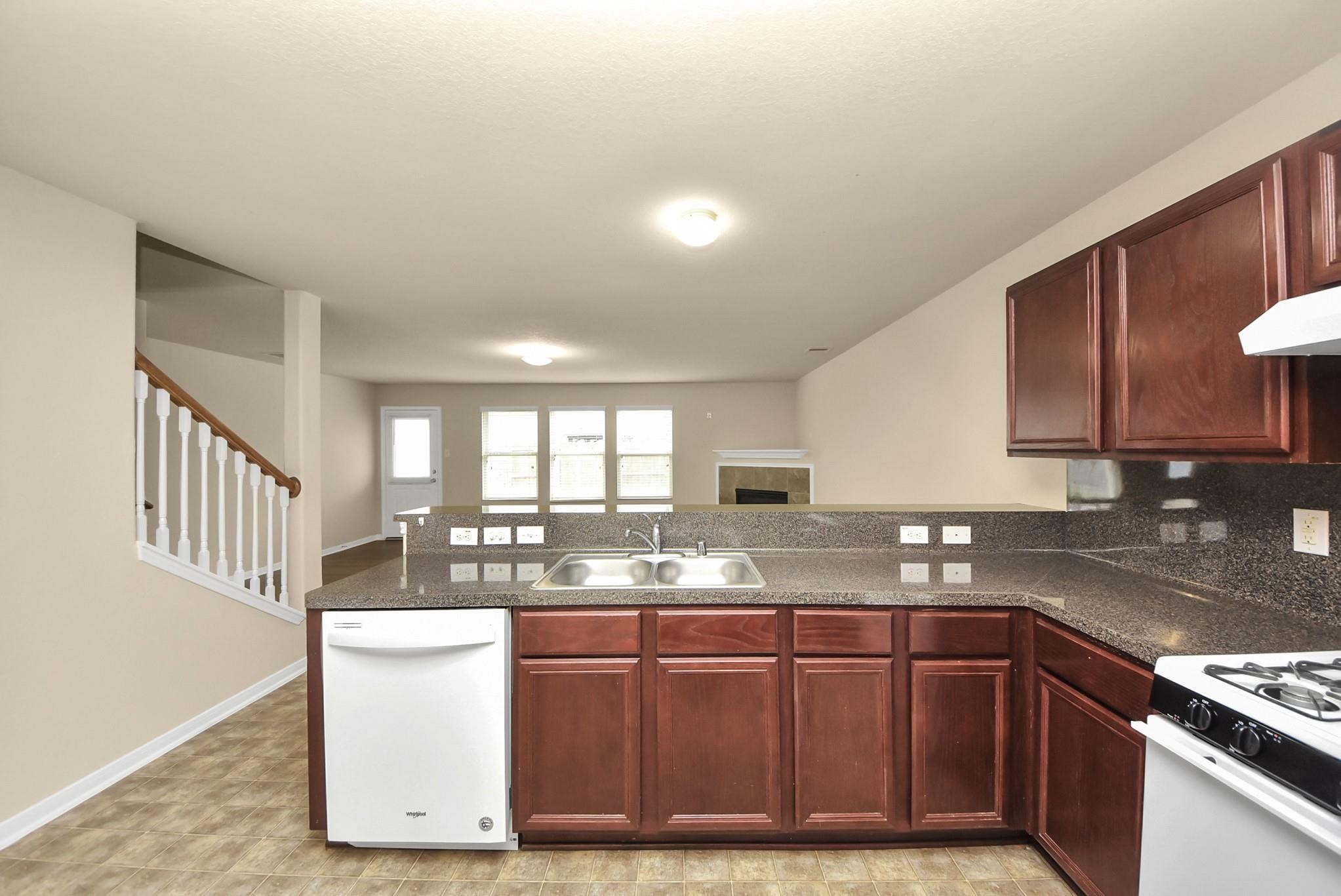 11014 Cape Rise Trail Houston, TX 77044 - Photo 8 of 43 A functional kitchen design featuring a double sink, breakfast bar, and open sightlines to the living area; creating a bright, connected space ideal for everyday living and gatherings.