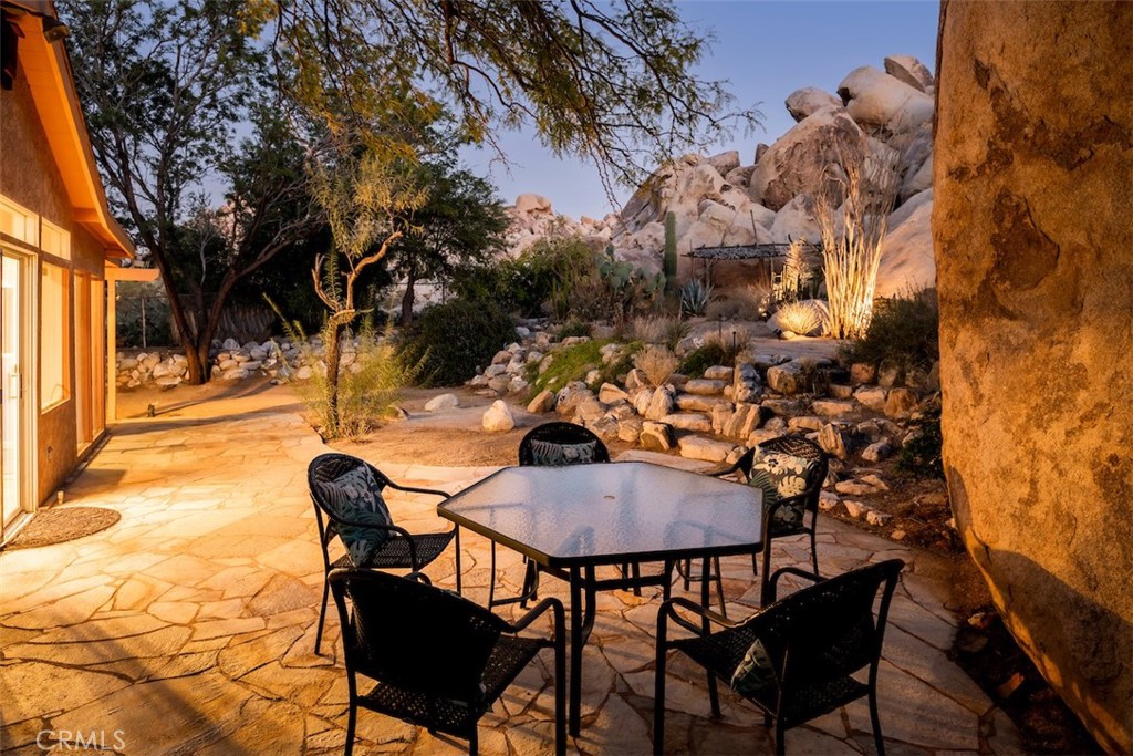 66075 Foothill Drive Joshua Tree, CA 92252 - Photo 23 of 53 a backyard of a house with table and chairs