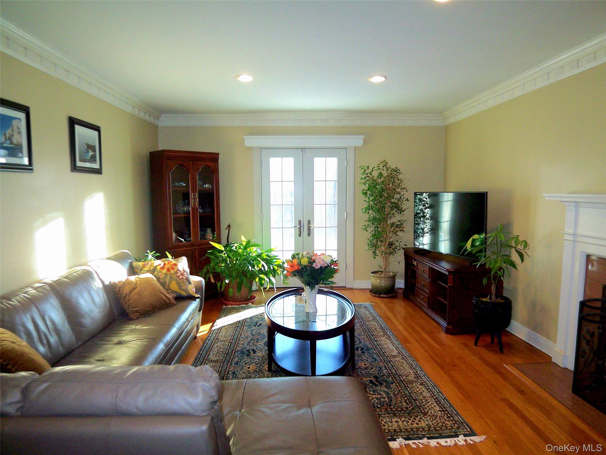 40 Harding Parkway Mount Vernon, NY 10552 - Photo 14 of 35 Living area with crown molding, french doors, wood finished floors, and recessed lighting