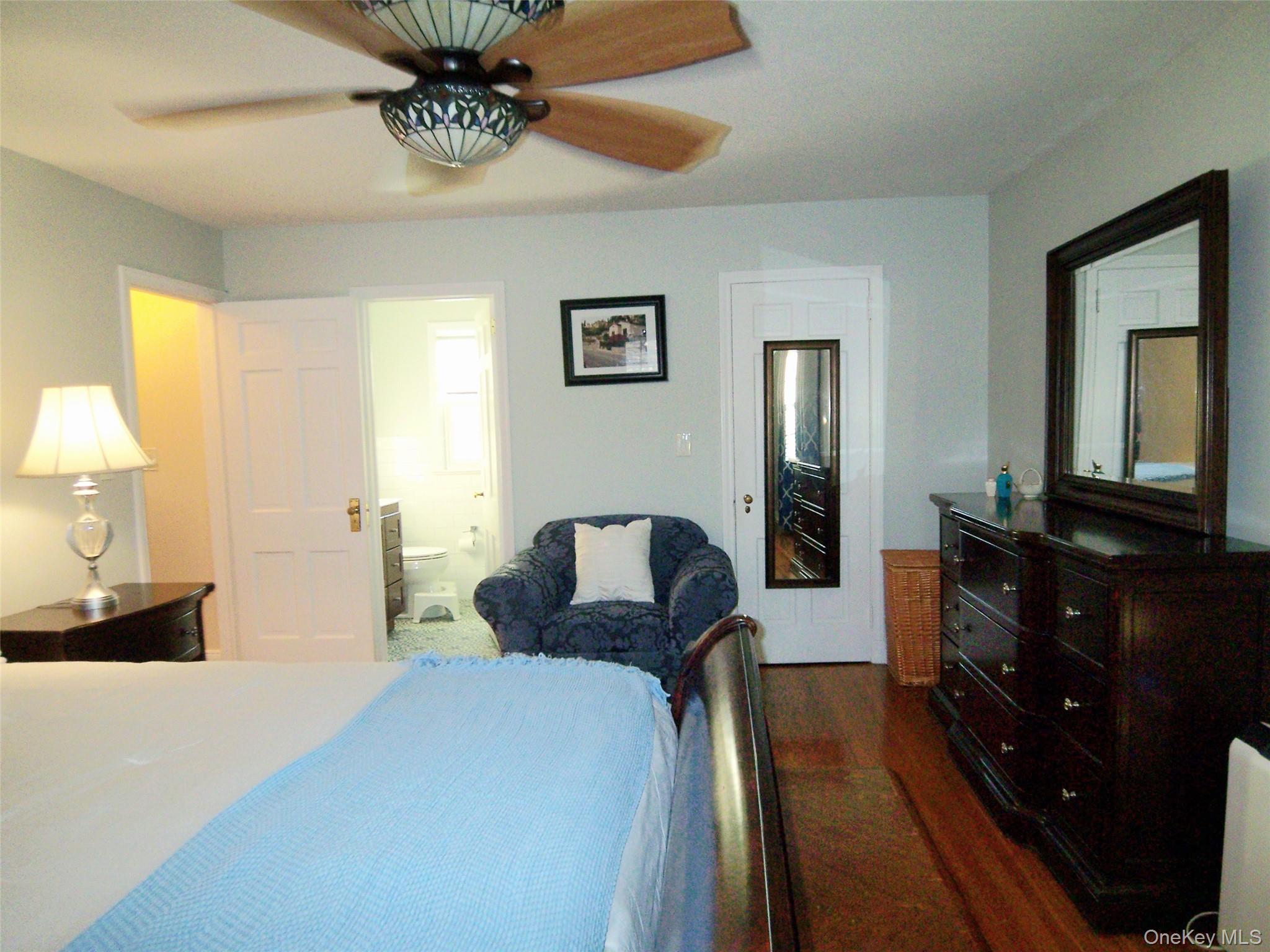 40 Harding Parkway Mount Vernon, NY 10552 - Photo 26 of 35 Bedroom with connected bathroom, dark wood-style floors, and a ceiling fan