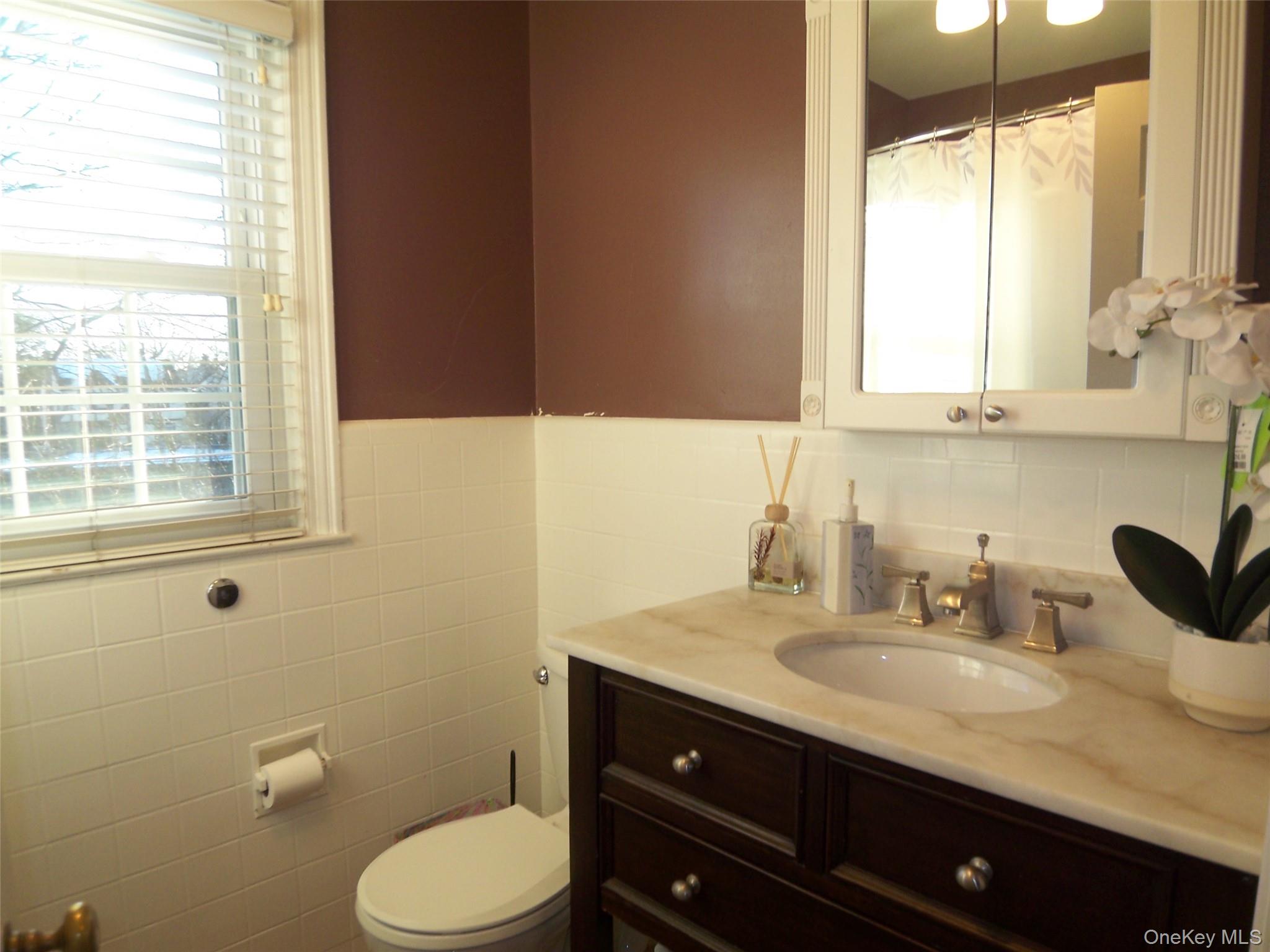 40 Harding Parkway Mount Vernon, NY 10552 - Photo 32 of 35 Full bath with vanity, curtained shower, wainscoting, and tile walls