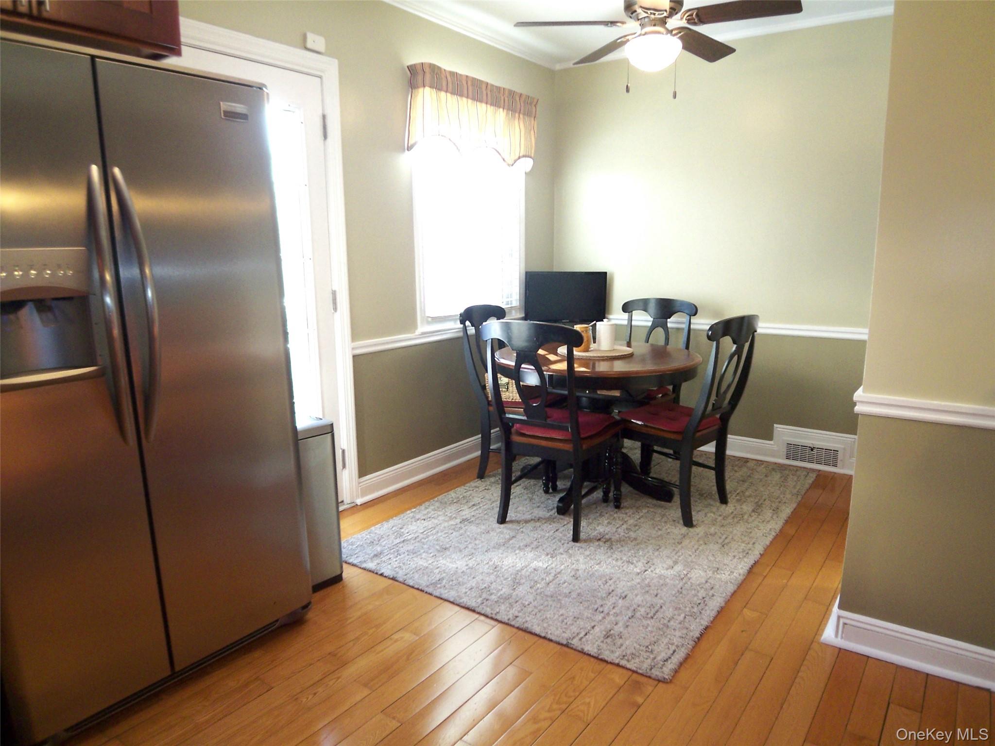 40 Harding Parkway Mount Vernon, NY 10552 - Photo 6 of 35 Dining area featuring light wood finished floors, crown molding, and ceiling fan