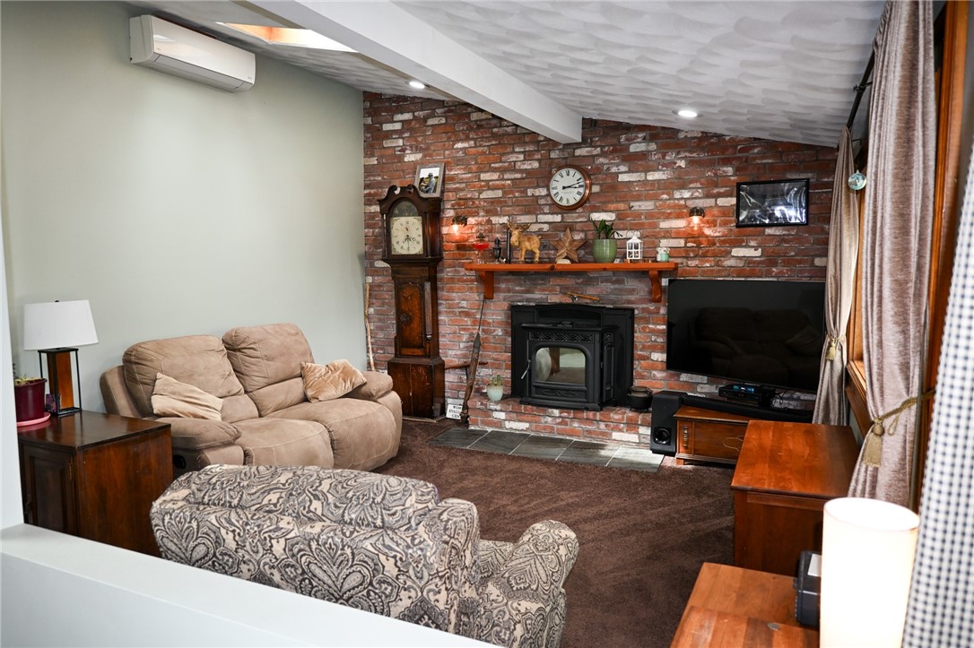 36 Pine Tree Road Coventry, RI 02816 - Photo 17 of 45 Brick accent wall with Harmon pellet stove