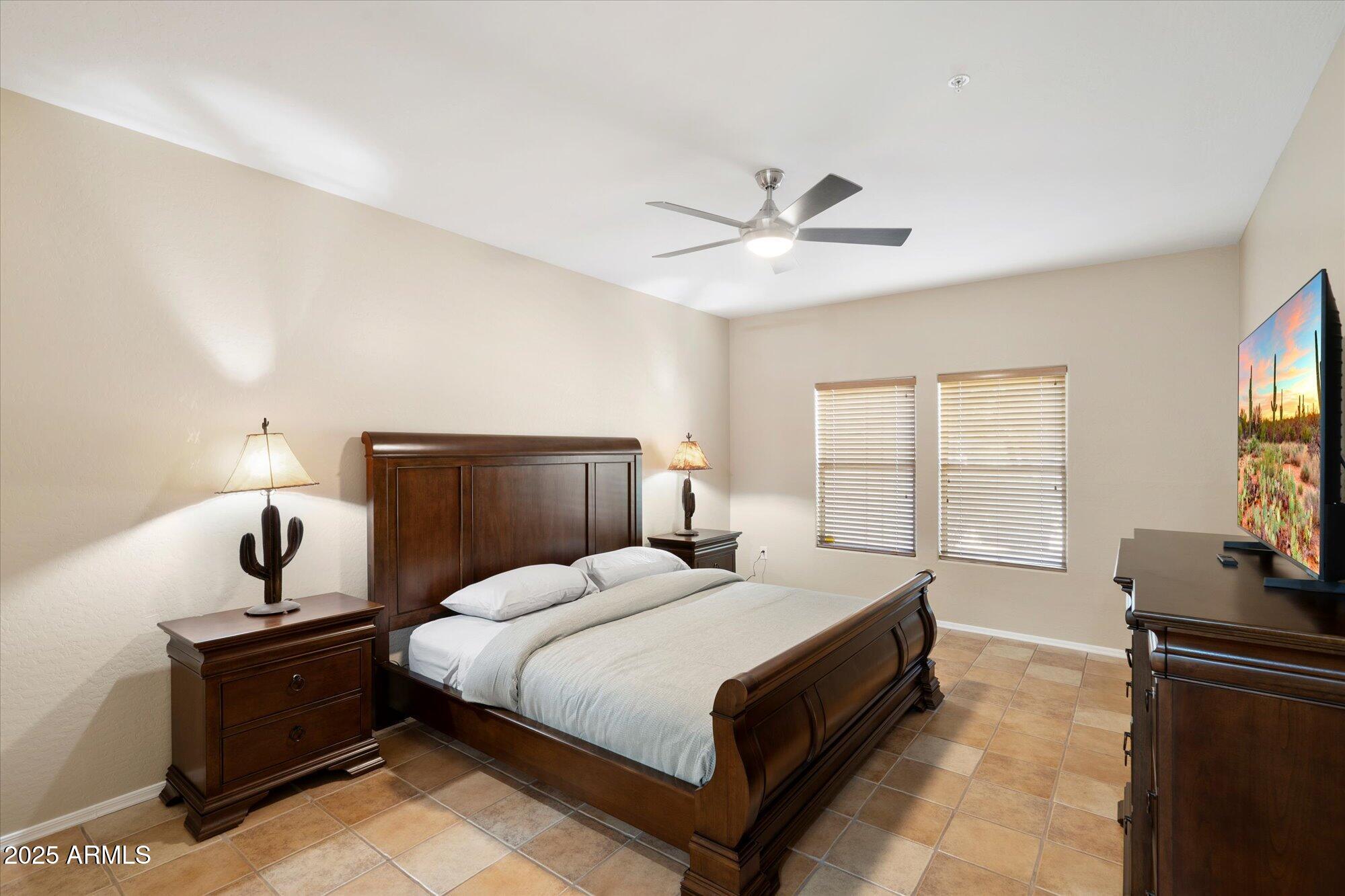 19700 North 76th Street, Unit 1103 Scottsdale, AZ 85255 - Photo 11 of 18 a bedroom with a bed and a flat screen tv