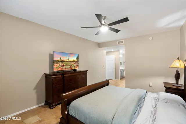 a bedroom with a bed and a flat screen tv