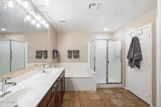 a bathroom with a double vanity sink a mirror and shower