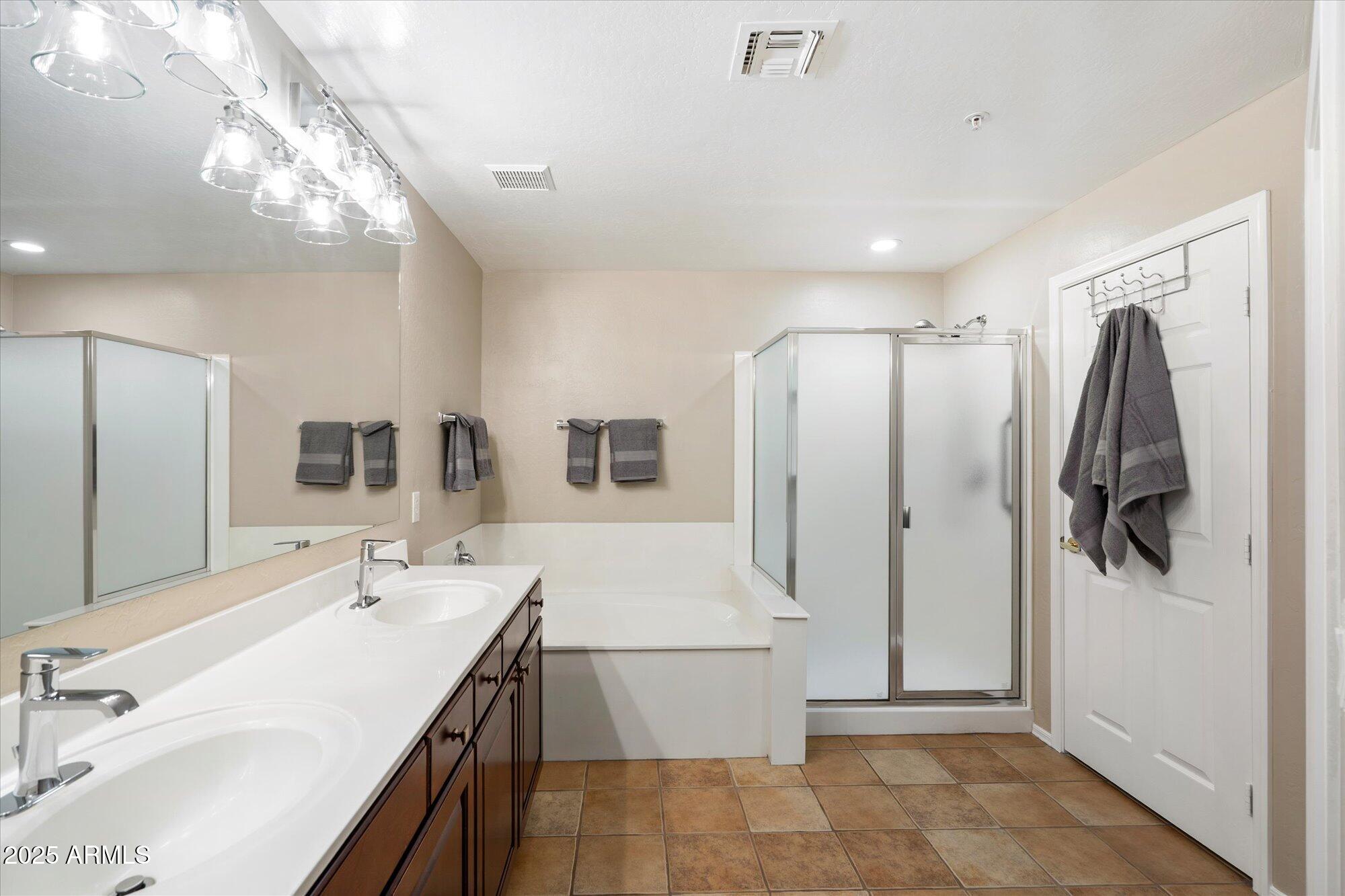 19700 North 76th Street, Unit 1103 Scottsdale, AZ 85255 - Photo 13 of 18 a bathroom with a double vanity sink a mirror and shower