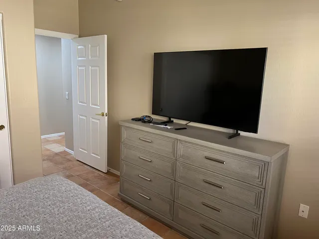 a room with a dresser and a flat screen tv
