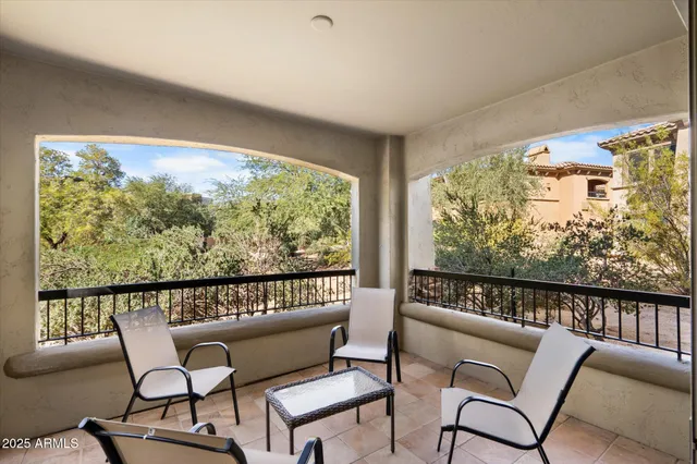 a roof deck with furniture and wooden floor