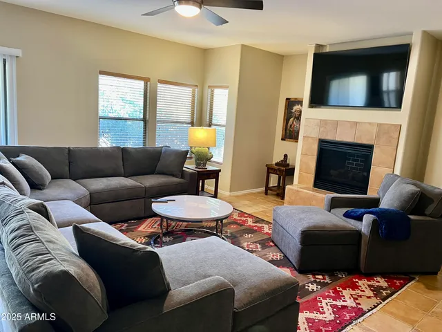 a living room with furniture fireplace and a flat screen tv
