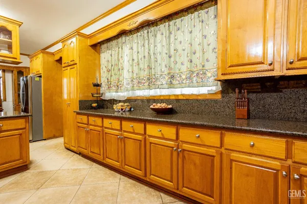 a bathroom with a granite countertop sink a toilet and a large mirror