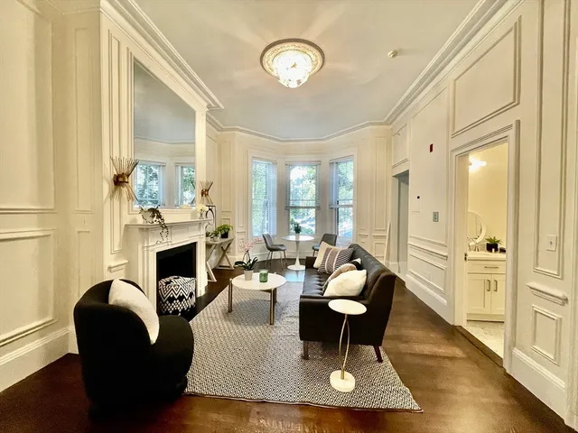 a living room with furniture a fireplace and a table