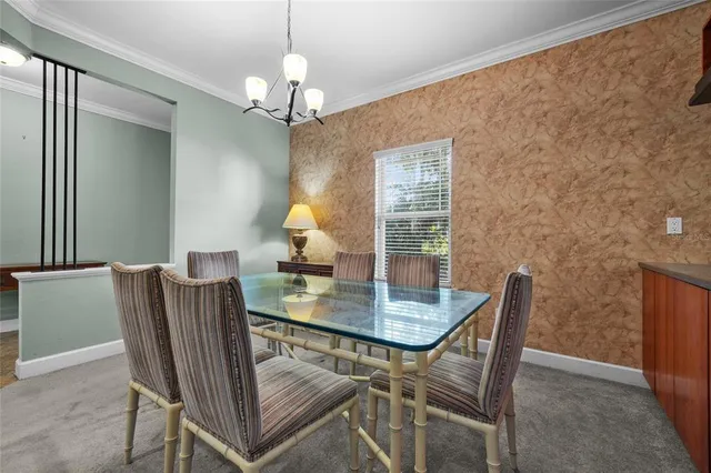 a view of a dining room with furniture and chandelier