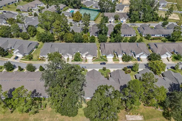an aerial view of a house with a yard and outdoor seating