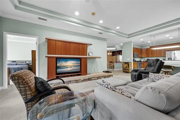 a living room with furniture a flat screen tv and a fireplace