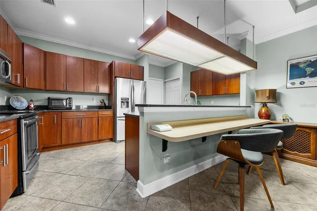 a kitchen with stainless steel appliances granite countertop a sink wooden cabinets and a counter top space