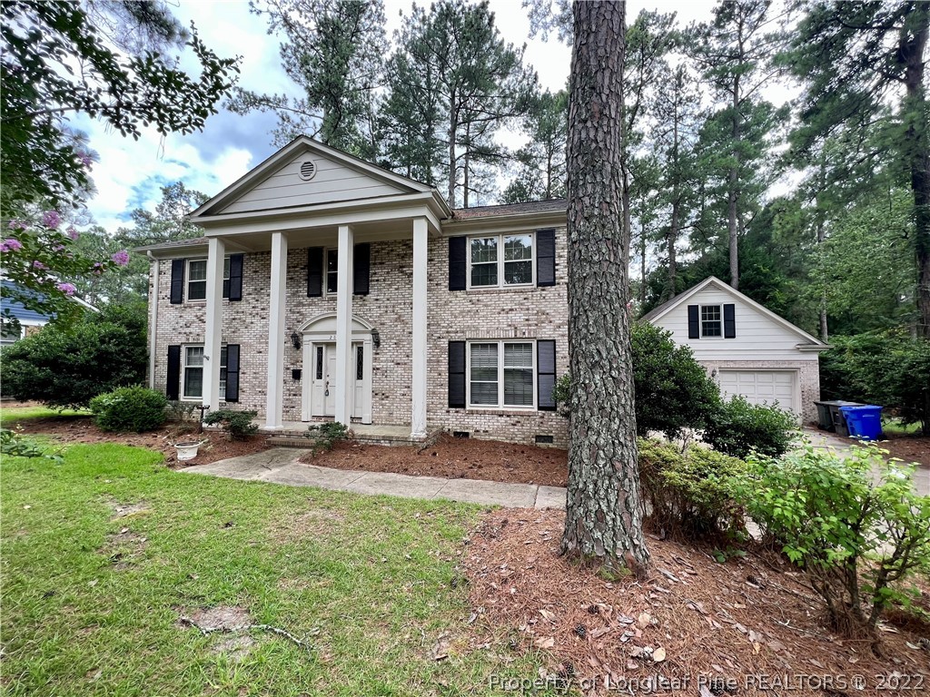 2823 Millbrook Road Fayetteville, NC 28303 - Photo 1 of 20 a front view of a house with a yard and trees
