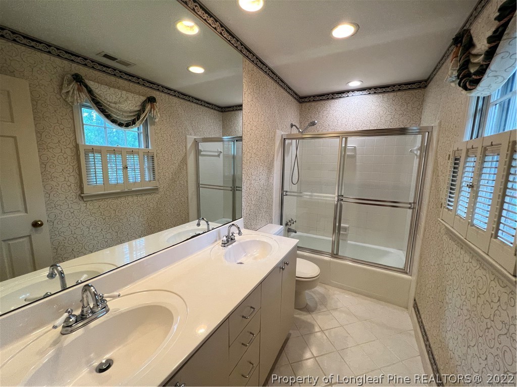 2823 Millbrook Road Fayetteville, NC 28303 - Photo 11 of 20 a bathroom with a sink double vanity and a mirror