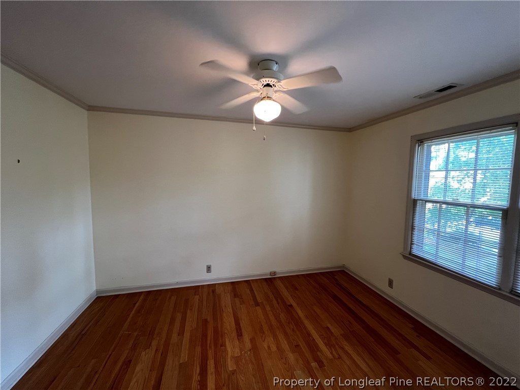 2823 Millbrook Road Fayetteville, NC 28303 - Photo 13 of 20 wooden floor in an empty room with a window