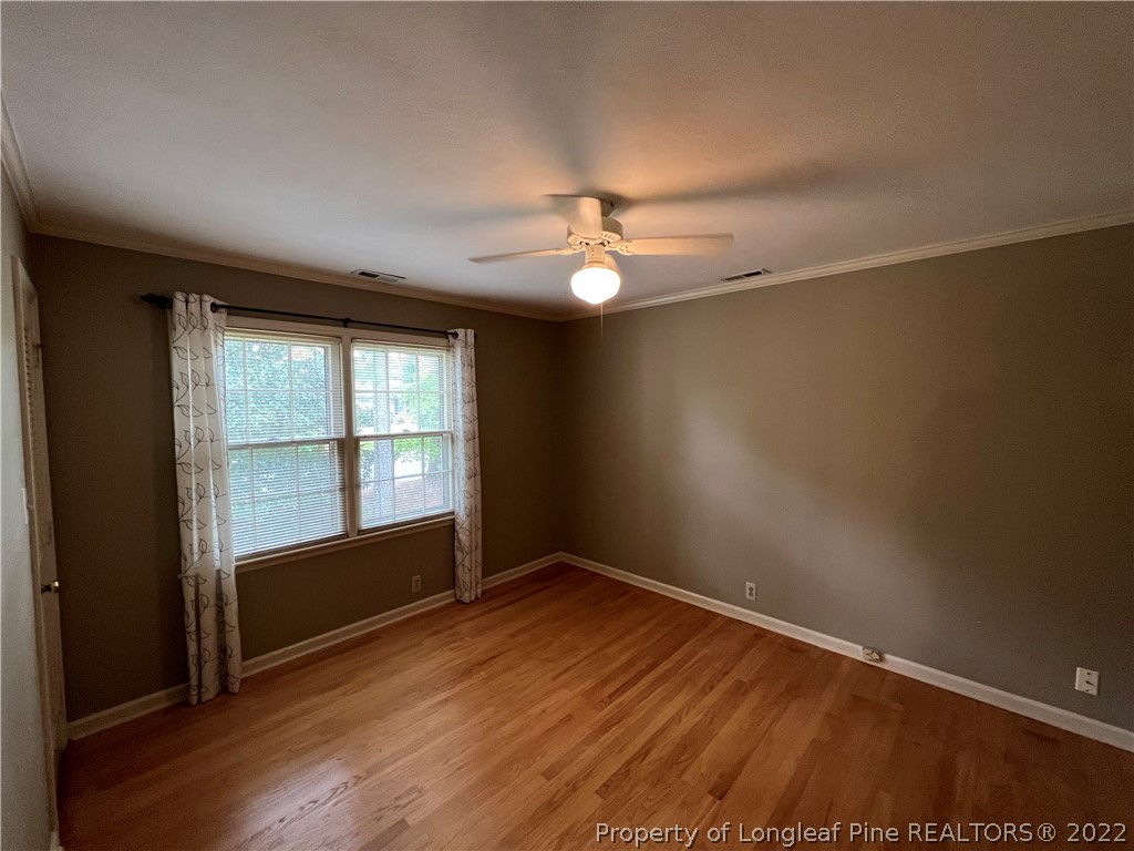 2823 Millbrook Road Fayetteville, NC 28303 - Photo 14 of 20 an empty room with wooden floor and windows
