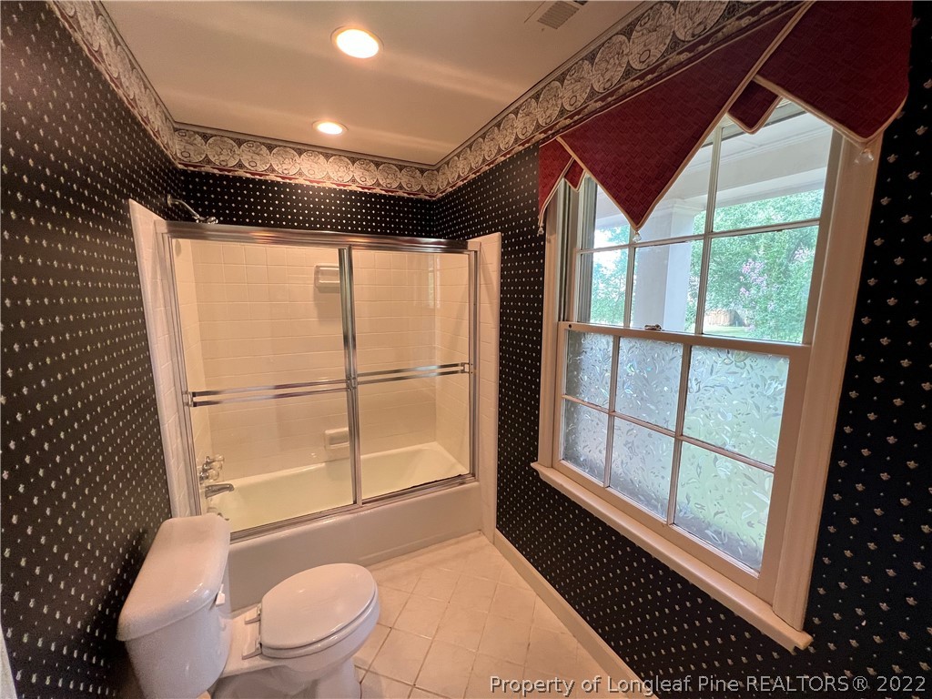 2823 Millbrook Road Fayetteville, NC 28303 - Photo 15 of 20 a bathroom with a toilet a sink and a shower