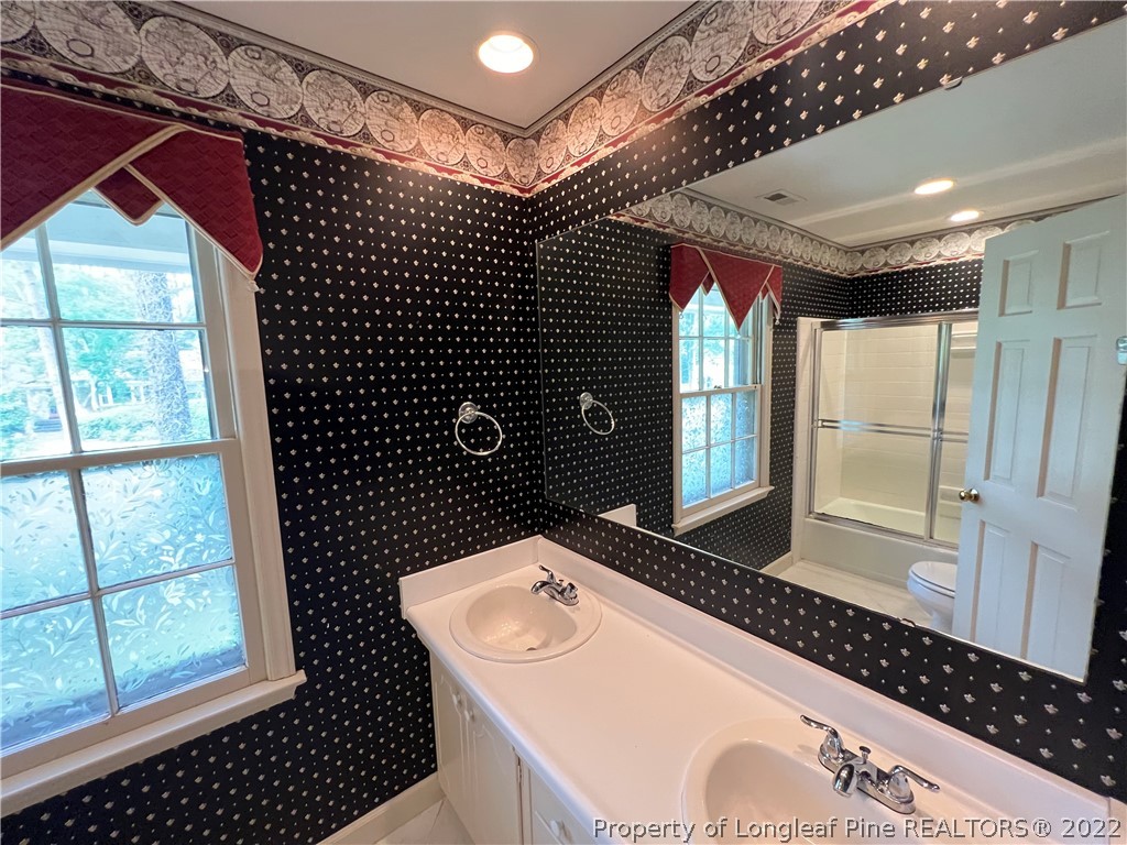 2823 Millbrook Road Fayetteville, NC 28303 - Photo 16 of 20 a bathroom with a sink toilet and shower