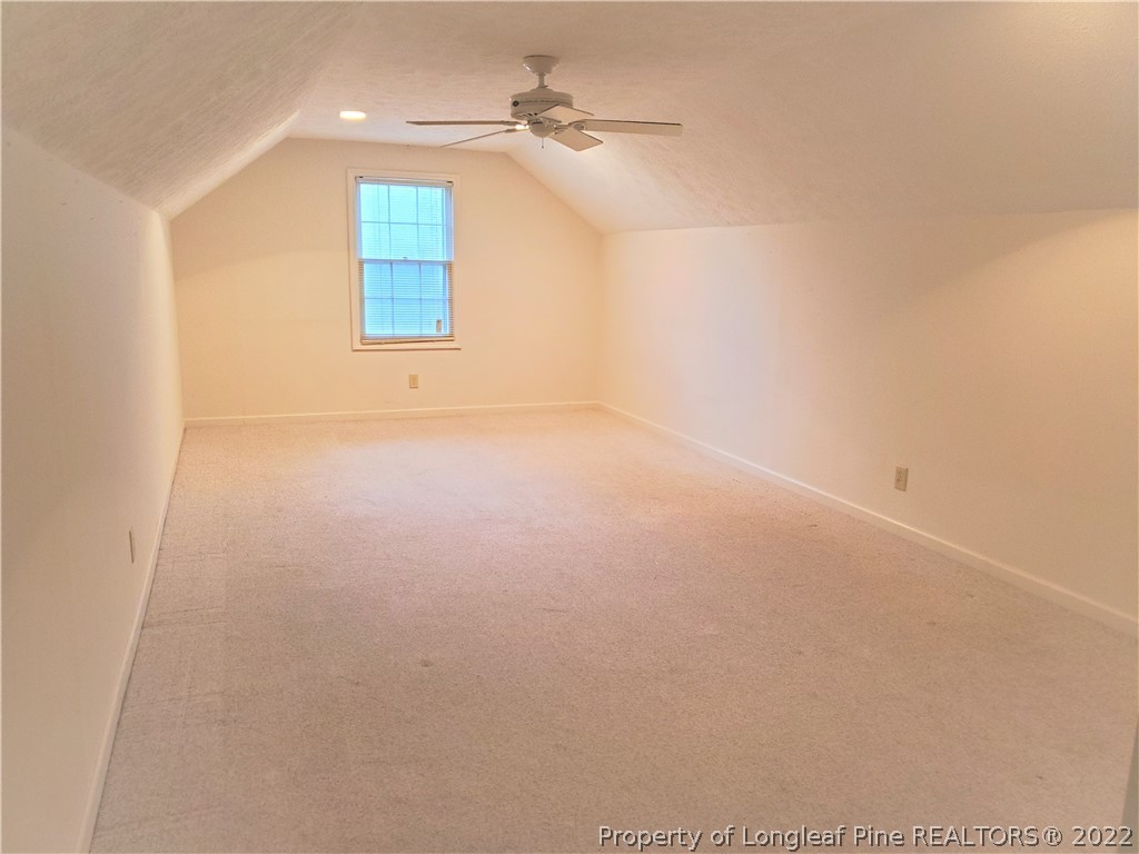 2823 Millbrook Road Fayetteville, NC 28303 - Photo 17 of 20 an empty room with windows and fan