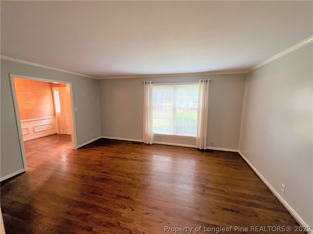 2823 Millbrook Road Fayetteville, NC 28303 - Photo 2 of 20 an empty room with wooden floor and windows