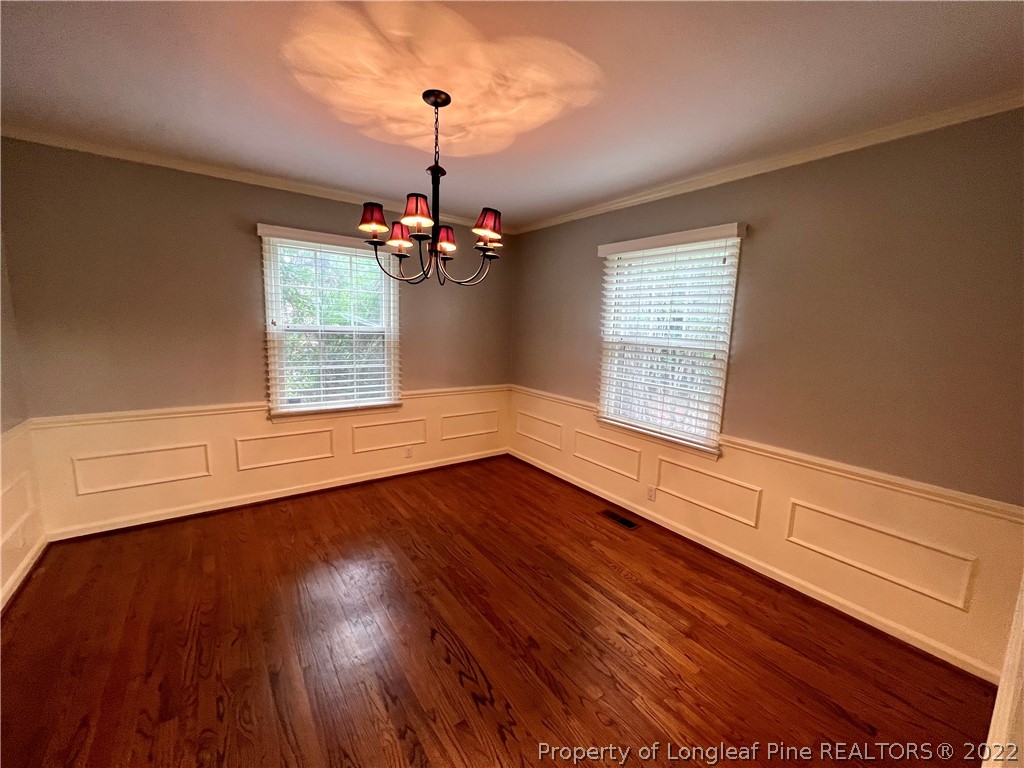 2823 Millbrook Road Fayetteville, NC 28303 - Photo 3 of 20 a view of an empty room with wooden floor and a window