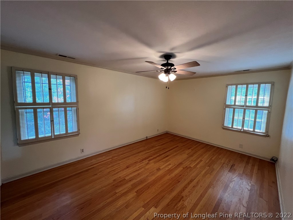 2823 Millbrook Road Fayetteville, NC 28303 - Photo 10 of 20 a view of an empty room with wooden floor and a window