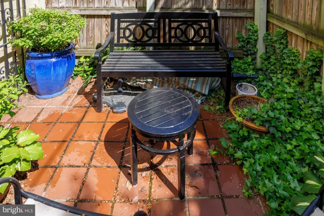 a view of a chairs and table in the balcony