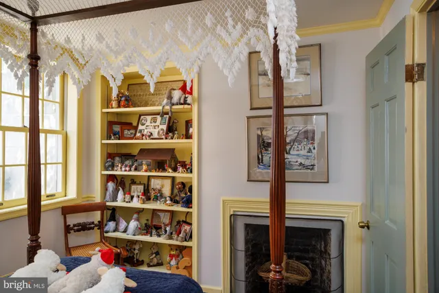 a room with lots of painting on the wall and a window