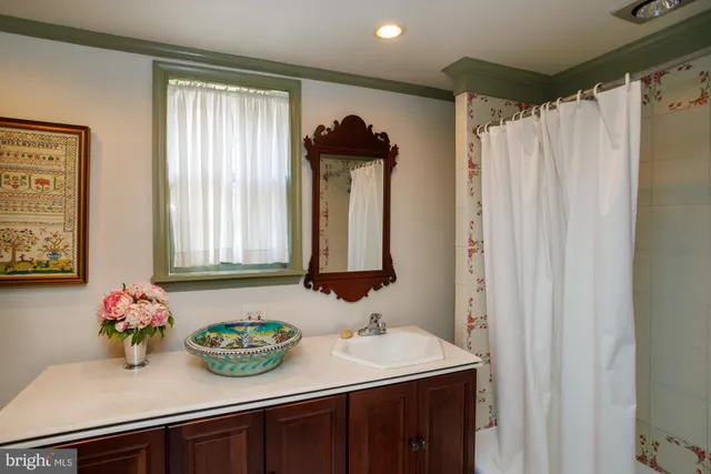a bathroom with a sink a mirror and a window